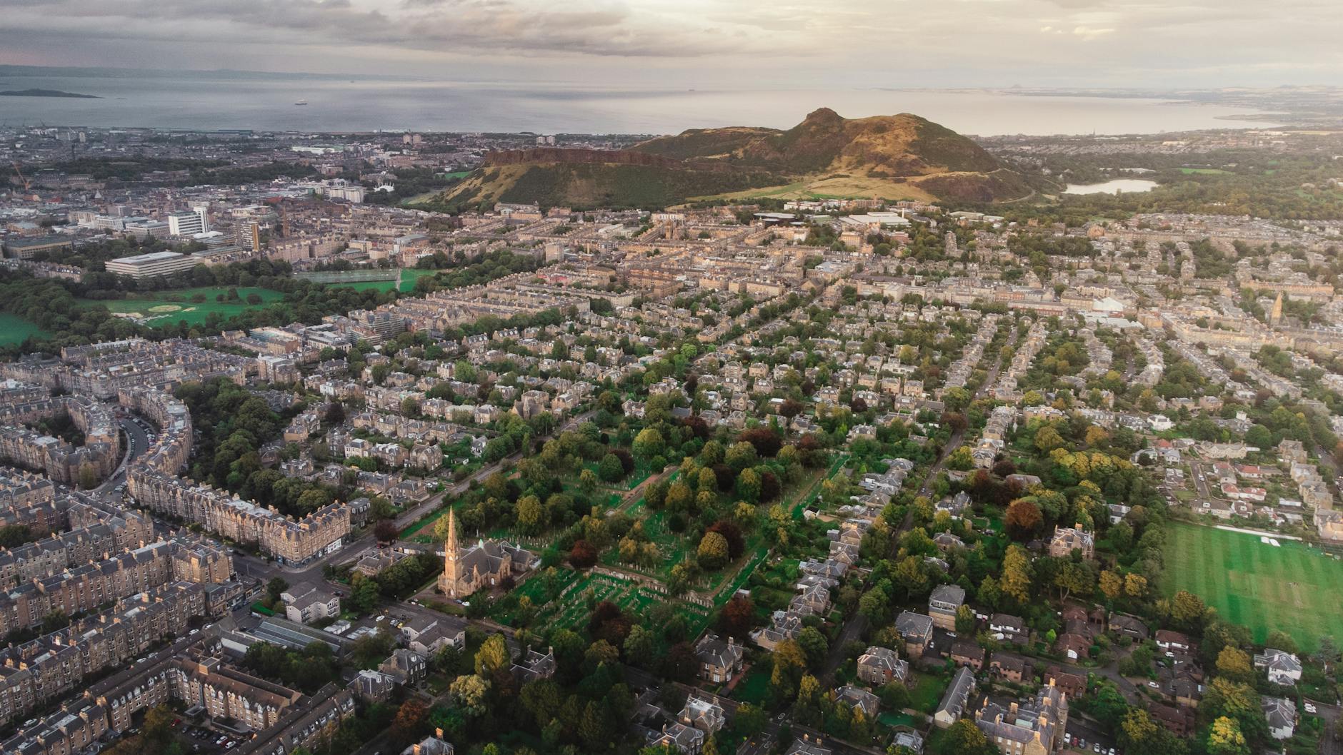 Hikers climbing Arthur Seat extinct volcano in Holyrood Park Edinburgh with city views