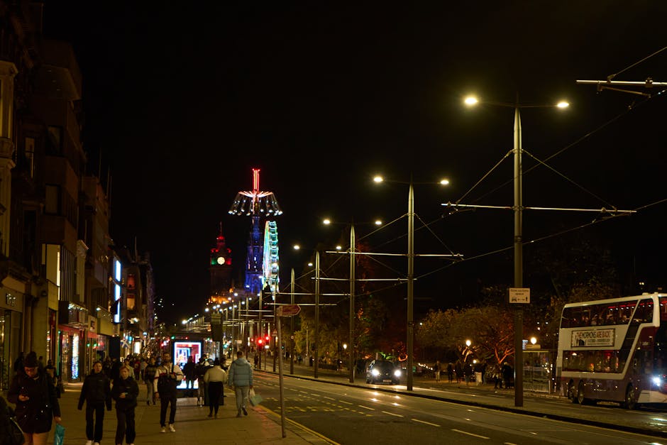 Edinburgh nighttime street scene with festive lights and bustling activity