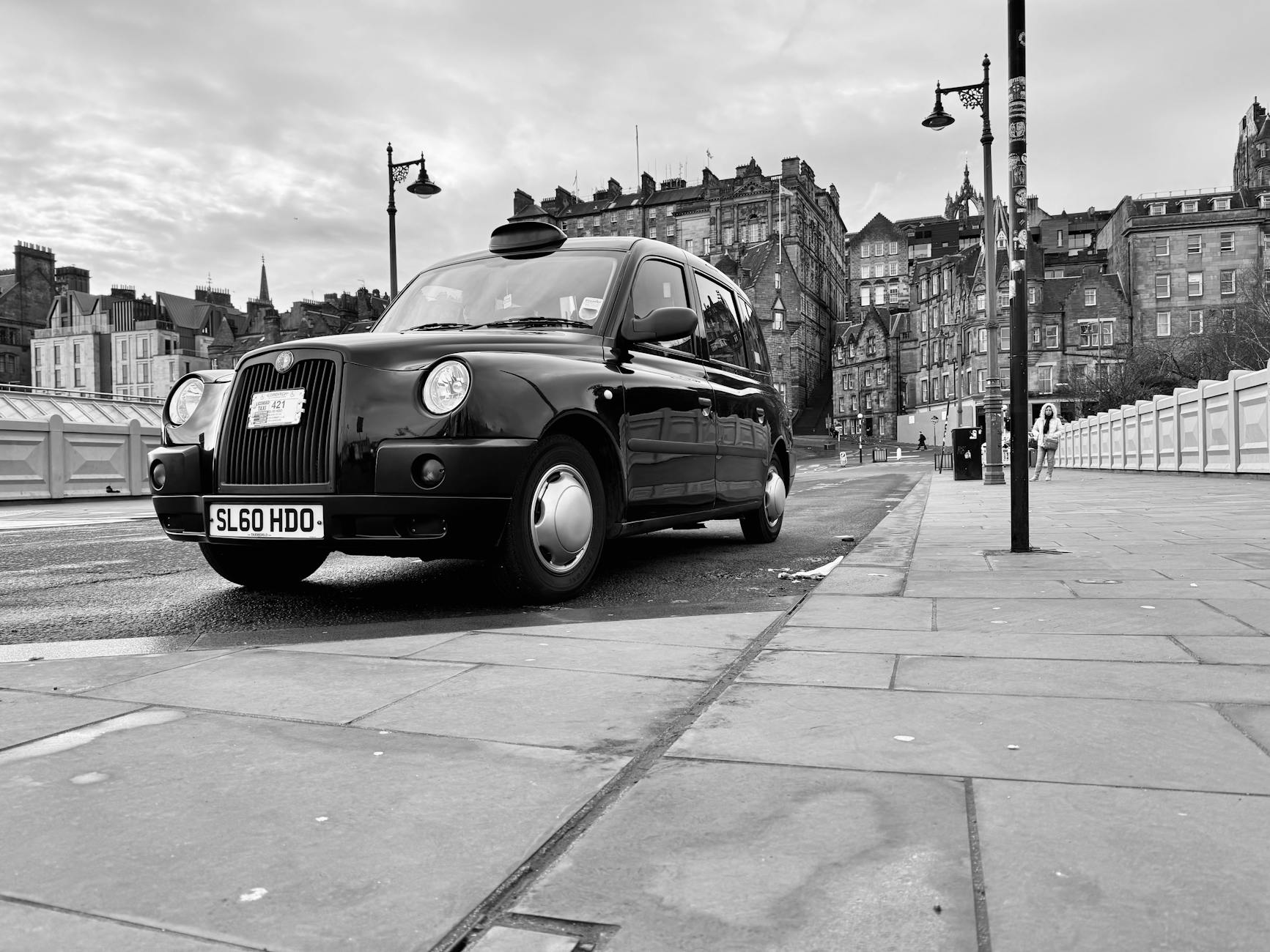 Black taxi cab waiting at a rank in central Edinburgh available for hire day and night