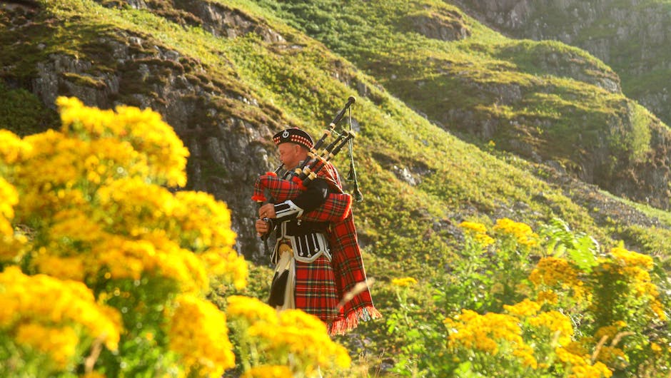 Scottish bagpiper in traditional kilt performing in Edinburgh