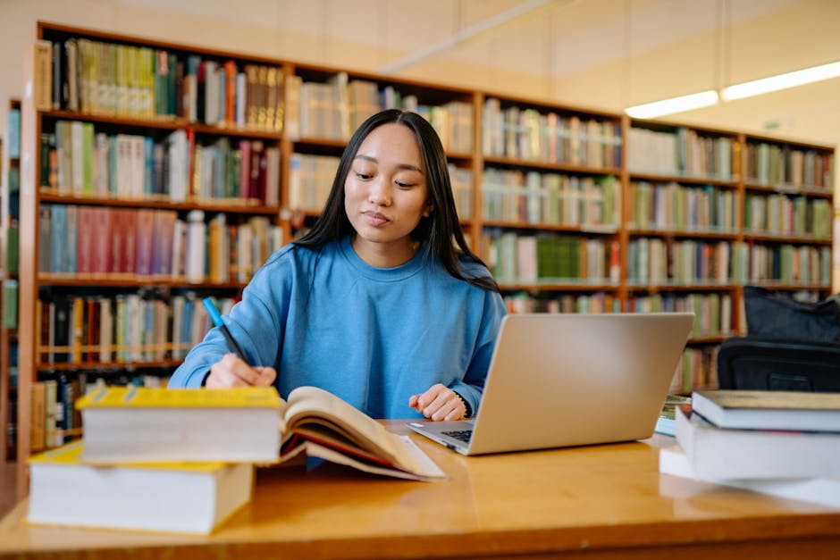 Student with laptop and books Edinburgh