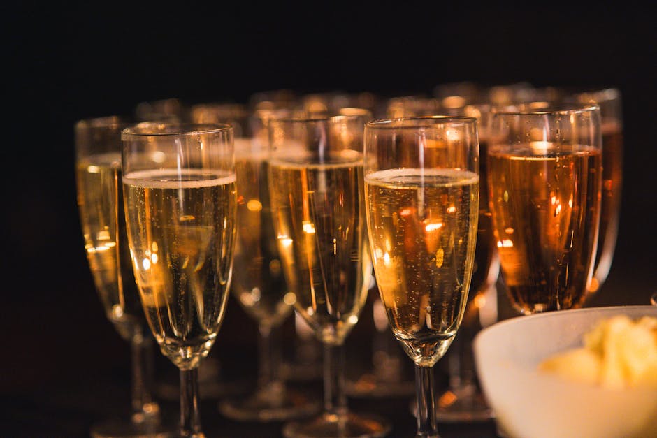 Rows of champagne flutes glowing in low light