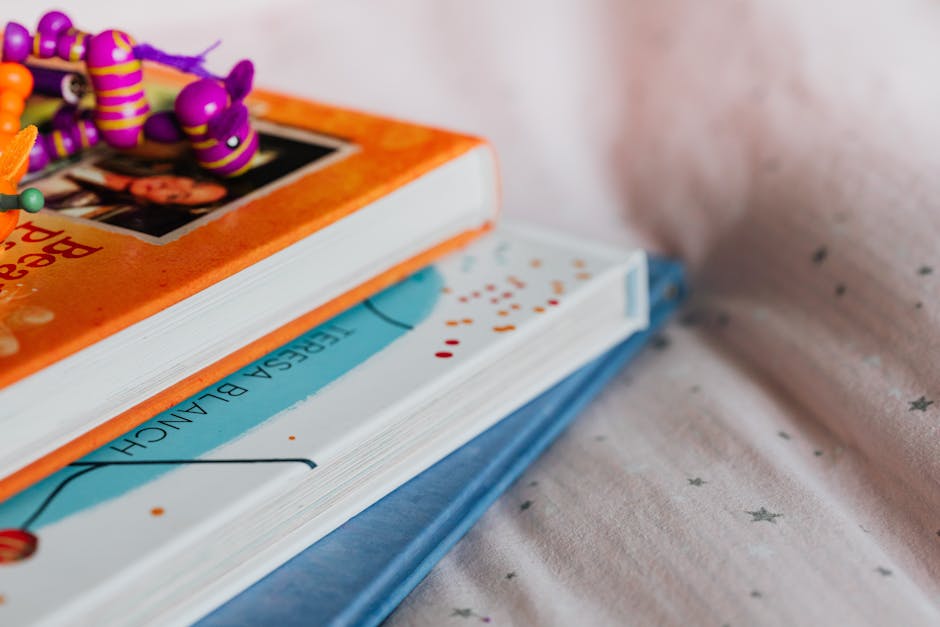 Children's picture books stacked on a blanket