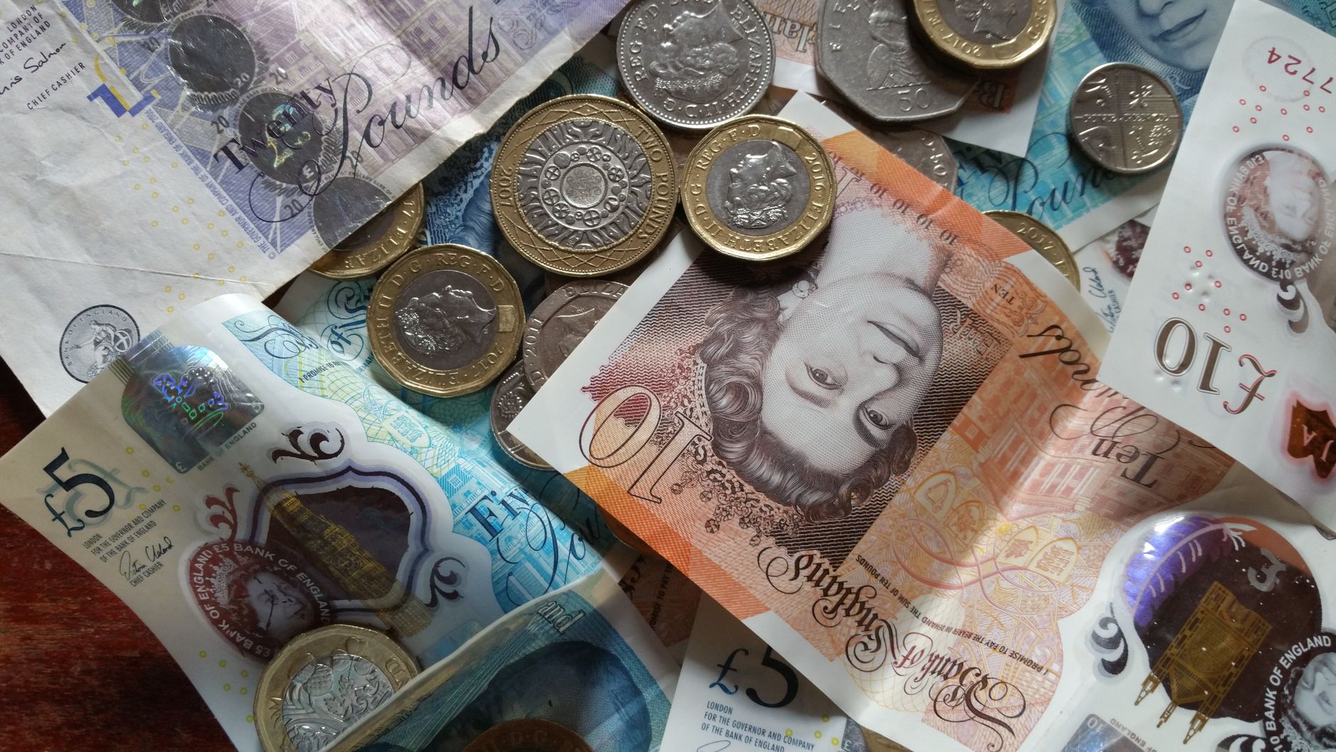 British pound sterling banknotes and coins used for spending money in Edinburgh