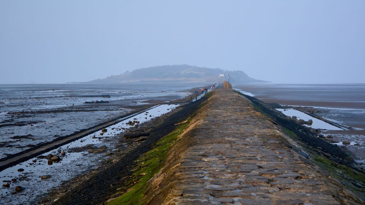 Stone causeway exposed at low tide leading out to Cramond Island near Edinburgh