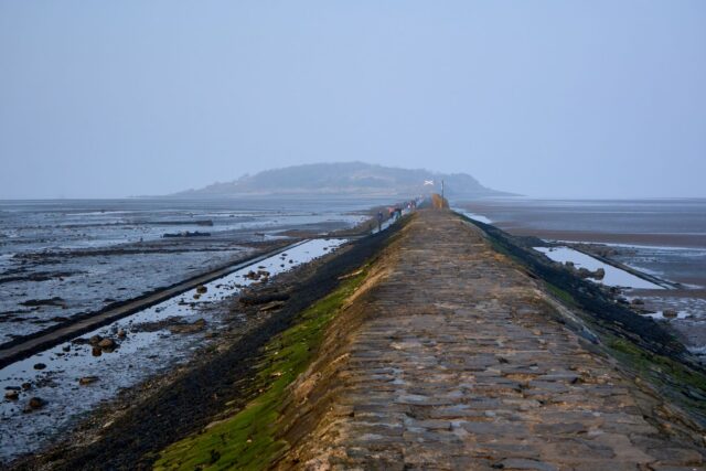 Stone causeway exposed at low tide leading out to Cramond Island near Edinburgh