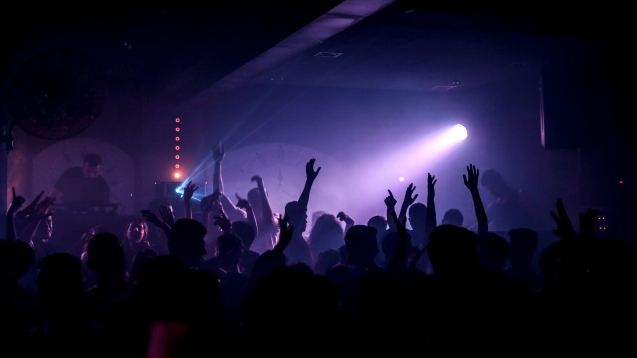Crowd dancing under coloured lights in an Edinburgh nightclub