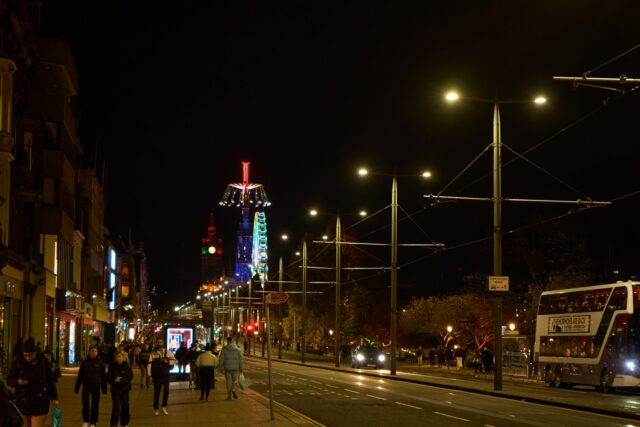 Princes Street Edinburgh at night with illuminated buildings and the Balmoral clock tower