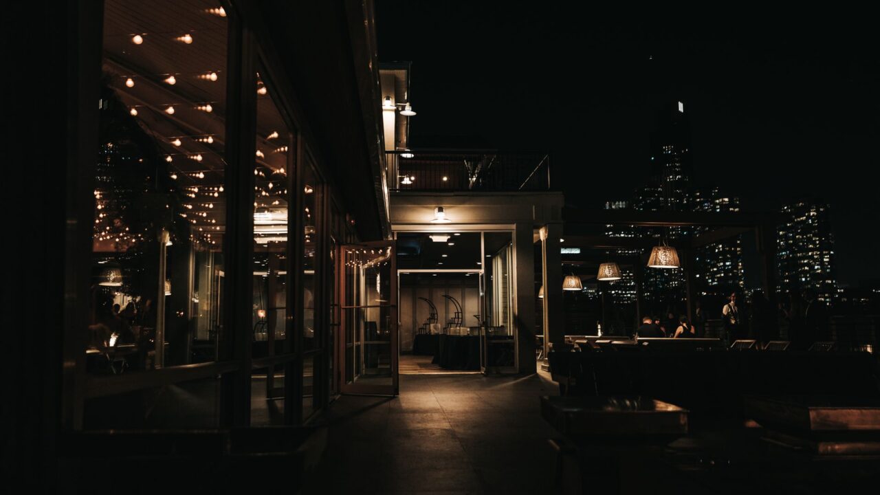 Rooftop bar at night overlooking a city skyline