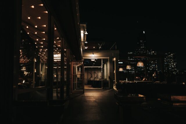 Rooftop bar at night overlooking a city skyline