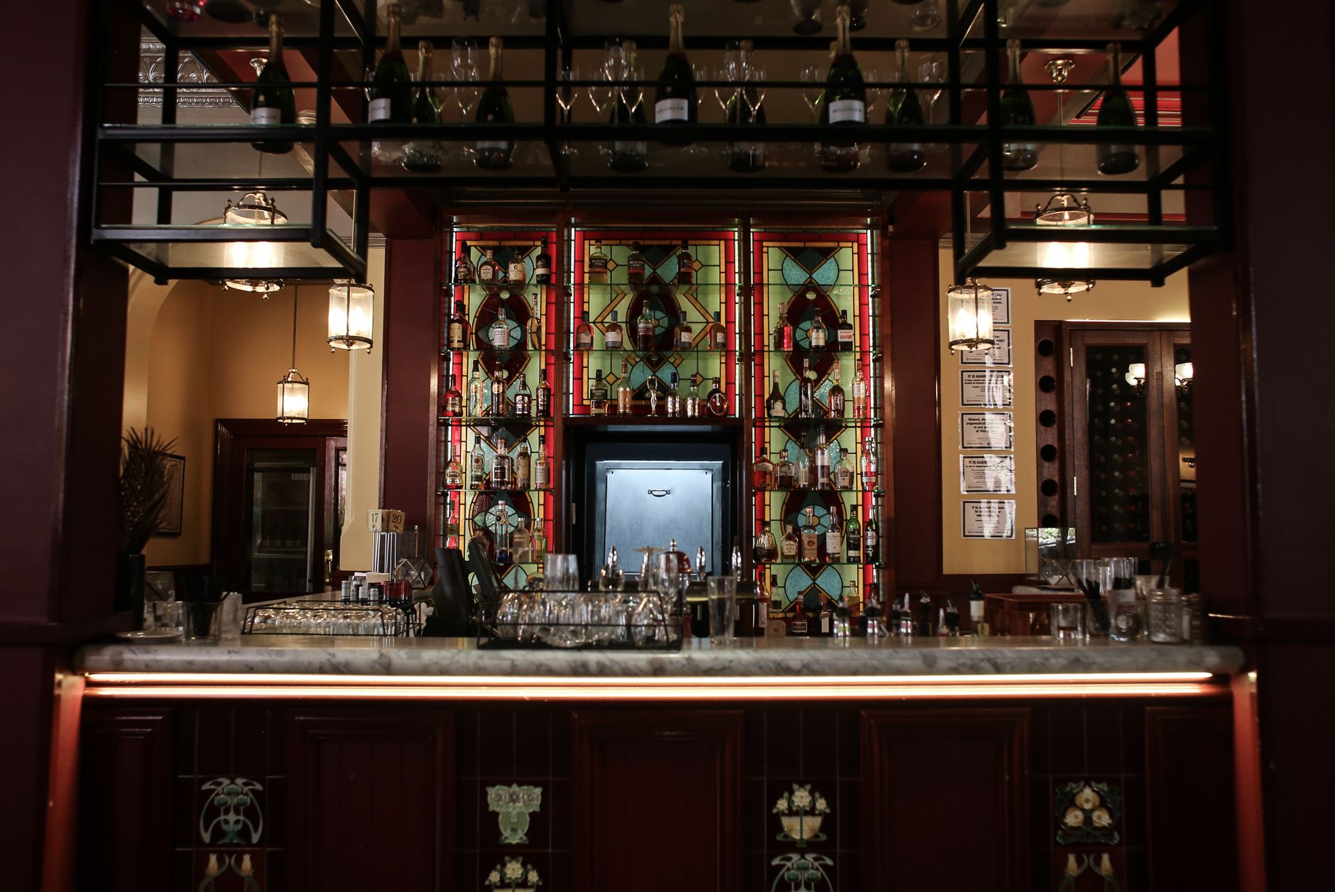 Ornate Victorian pub interior in Edinburgh with stained glass gantry and marble bar
