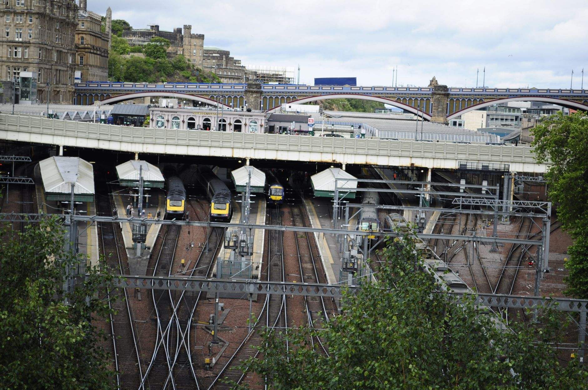 Train arriving at a station platform on the route to Edinburgh Waverley
