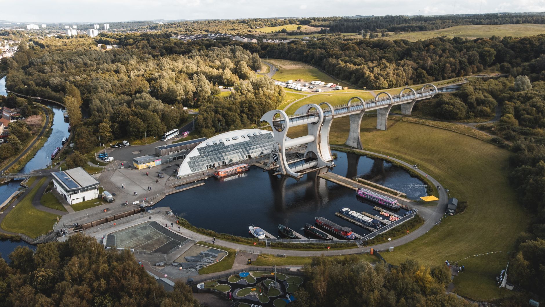 Aerial view of the Falkirk Wheel rotating boat lift, its aqueduct and the canal basin
