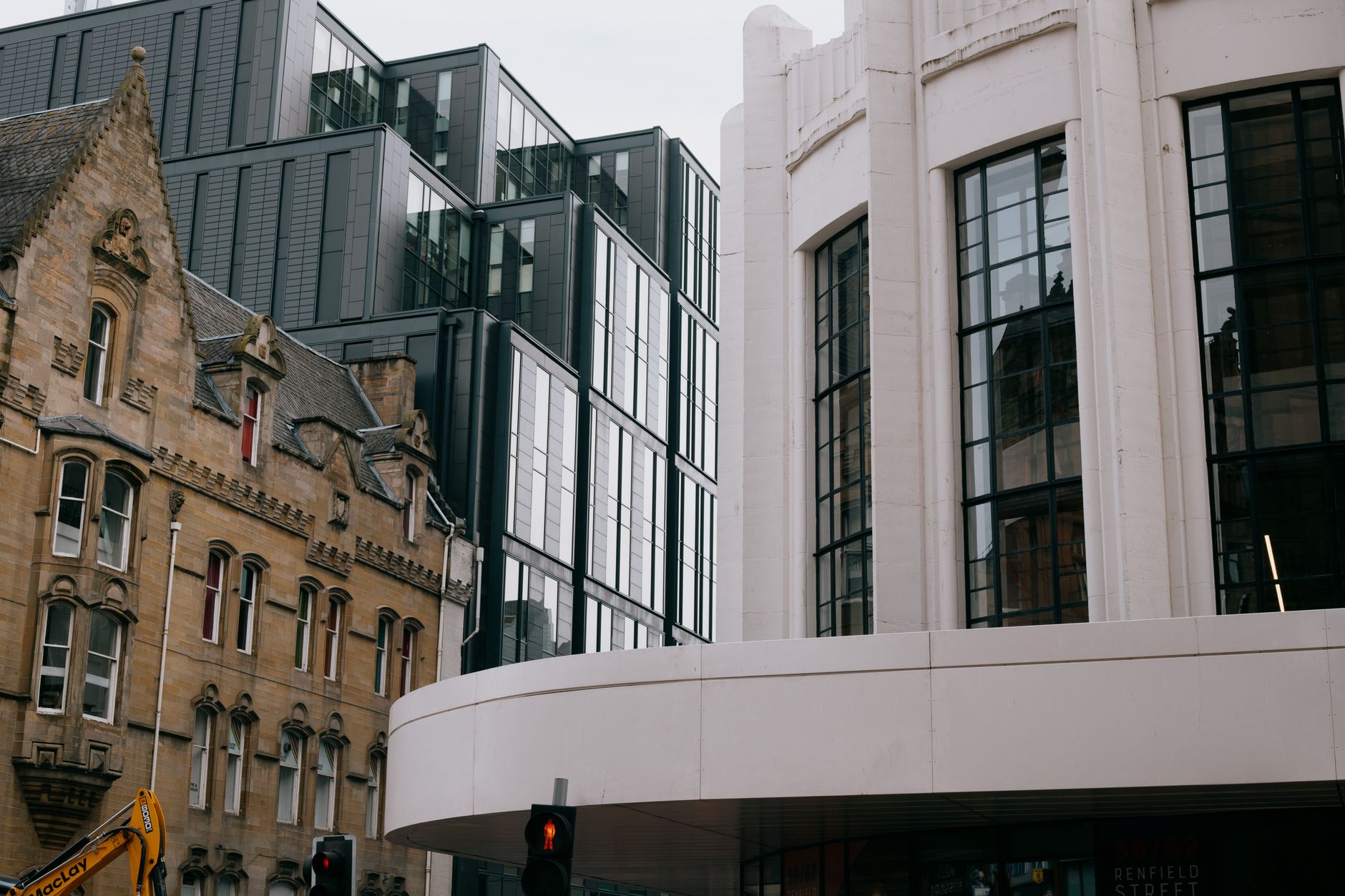 Victorian sandstone and modern glass architecture side by side on a Glasgow city centre street