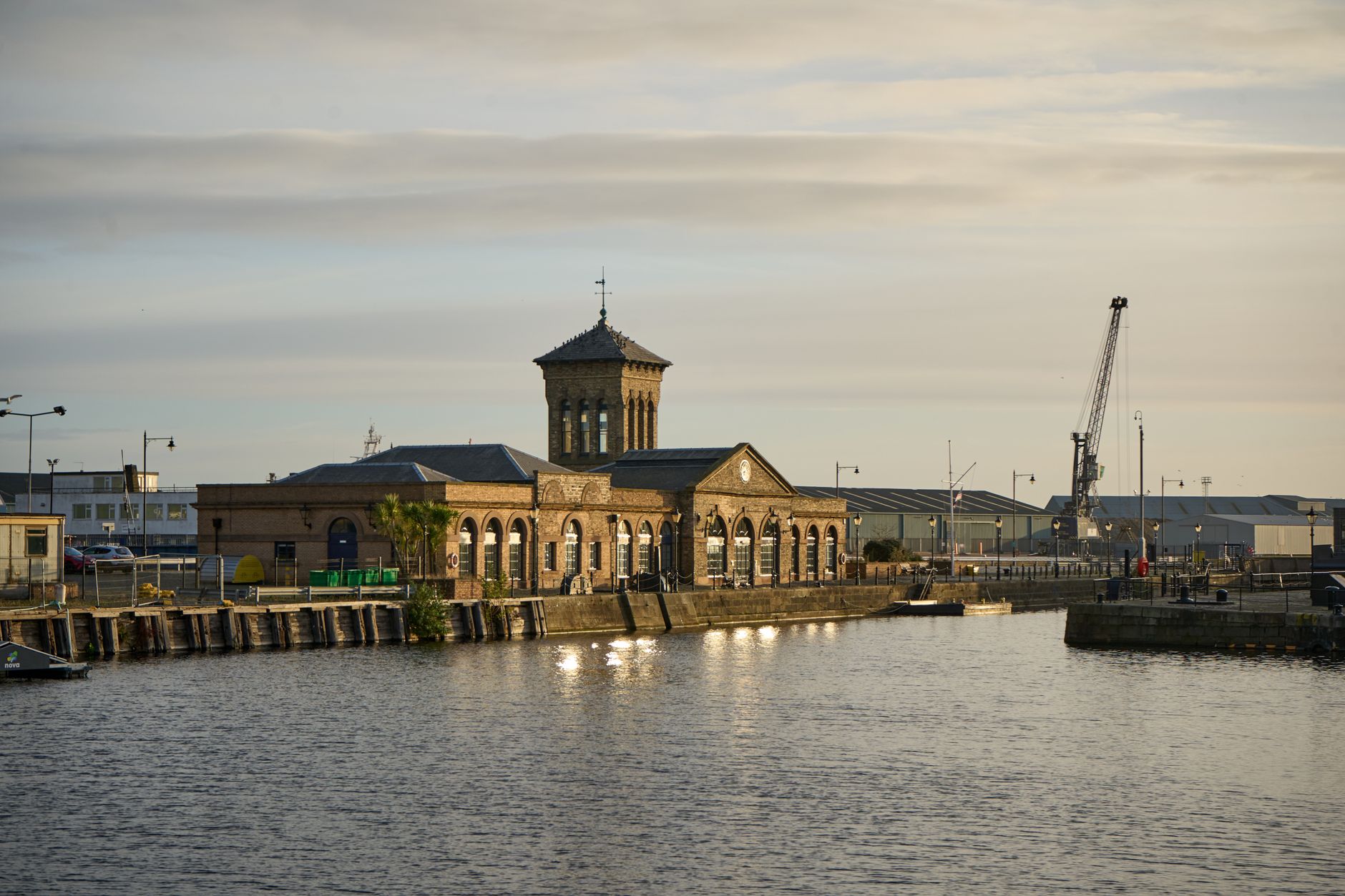 Leith harbour waterfront in Edinburgh at sunset with a dockside crane