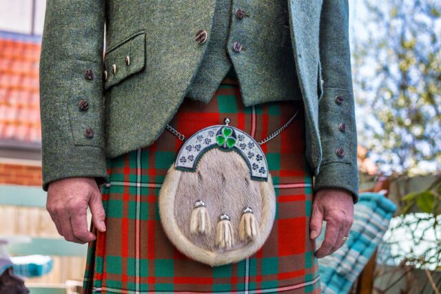 Man wearing a traditional Scottish kilt with sporran and tweed jacket