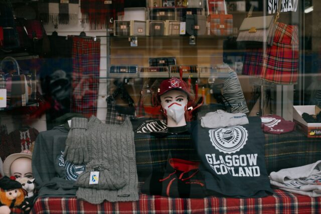 Scottish souvenir shop window with tartan scarves, knitwear and slogan t-shirts