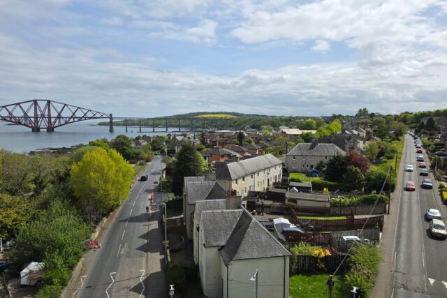 Aerial view of South Queensferry village with the Forth Bridge beyond