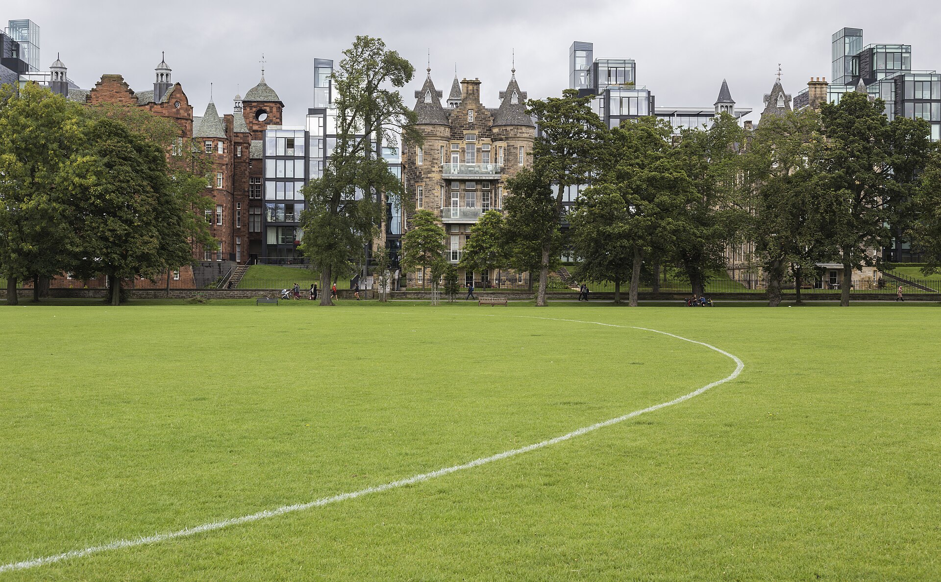 The Meadows in Edinburgh has broad green playing fields beside trees and the historic and modern buildings of Quartermile.