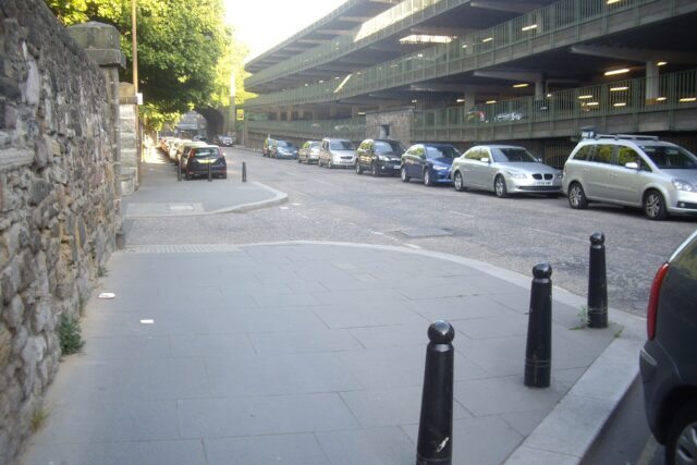 Parked cars beside the multistorey Castle Terrace car park on King's Stables Road in Edinburgh.